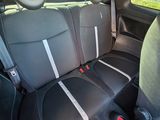 the back seats of a car are black and grey with white stripes