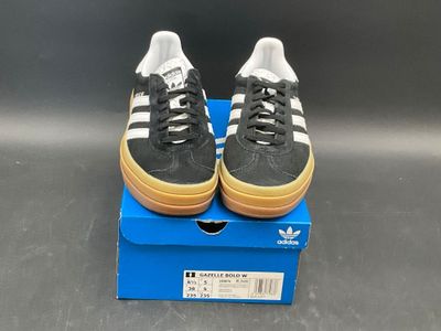adidas superstar shoes in black and white with gum soles