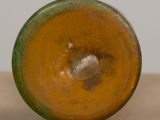 a close up of a green and yellow object on a table