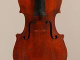 un vieux violon posé sur une surface blanche