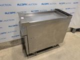 an image of a stainless steel box sitting on wheels in front of a wall