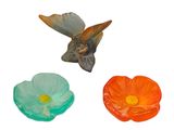 three different colored flowers and a bird on a white background