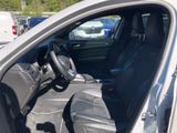 the interior of a car with the door open and the driver ' s seat down