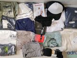 a lot of clothing and a hat on a table