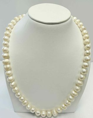 gros plan d'un collier de perles sur un mannequin