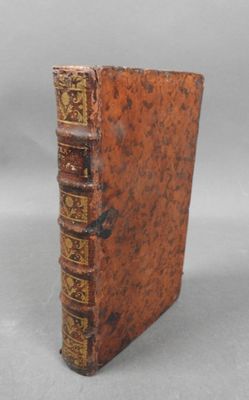 a close up of a book on a white surface with a gray background