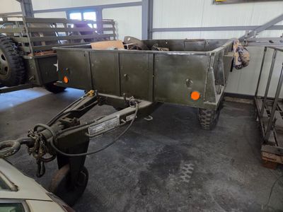 a truck with a trailer attached to it in a garage