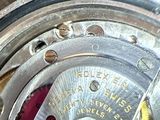 a close up of a watch with a metal case