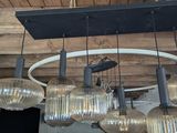 a chandelier that has a lot of lights hanging from it