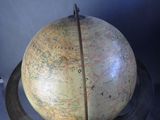 a large globe on a stand with a map on it