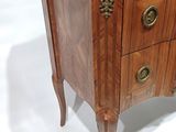 a small wooden table with a marble top on it