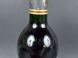 an image of a bottle of wine sitting on top of a table