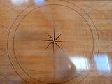a wooden floor with a circular design on it
