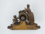 a statue of a woman and a child on a clock