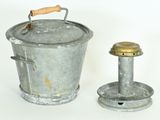 a metal bucket with a wooden handle next to a metal bucket with a wooden handle