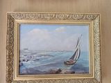 a picture of a painting hanging on a wall next to a picture of a sailboat