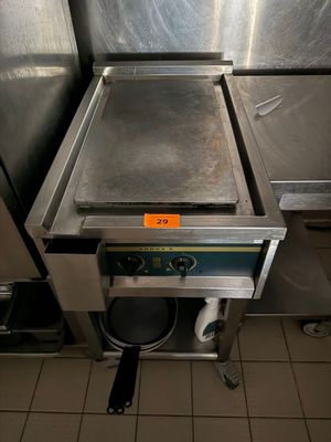 a large stainless steel pan sitting on top of a stove