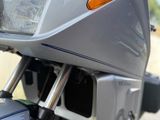 a close up of a motorcycle parked on the side of the road