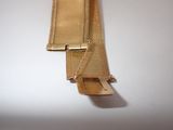 an image of a close up of a gold bracelet on a white surface