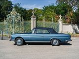 a blue car that is parked in front of a gate