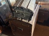 a pile of old suitcases and boxes in a room