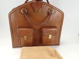 brown leather briefcase with two compartments and a tan cloth