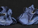 two pairs of blue shoes with a black background and a black background