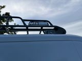 a white van with a metal roof rack on top of it