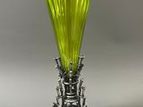 an image of a green vase sitting on top of a metal stand