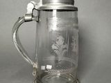 a glass beer mug with a handle on a table