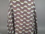 the back view of a woman ' s blouse with a wavy pattern