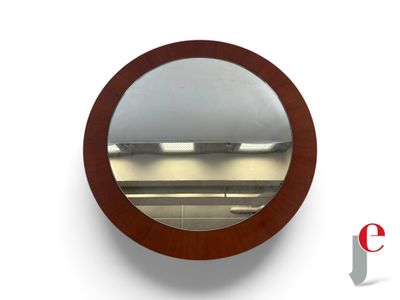 a round mirror hanging on a wall in a room