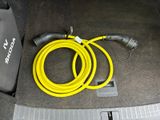 a yellow hose connected to a yellow hose in the trunk of a car