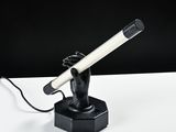 a black and white photo of a hand holding a hair dryer