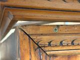 a close up of a wooden cabinet with a metal knob