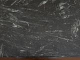 a black and white marble slab on a wooden table