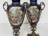pair of blue and gold vases sitting on top of a table