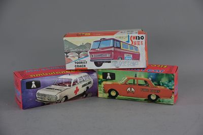 three boxes of toy cars sitting on top of a gray surface