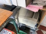 an image of a cluttered room with a computer and a printer