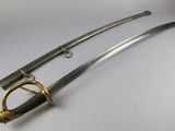 an image of a pair of swords sitting on top of a table