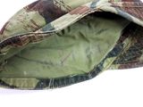 a close up of a camouflage hat on a white background