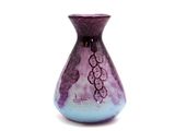 a purple and blue vase sitting on a white surface