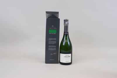 the bottle of wine is next to the box on the table
