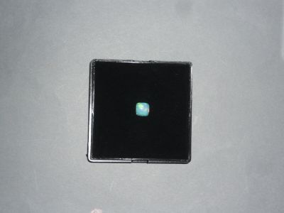 a small black square with a green light in it