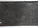 a piece of metal that is hanging on the wall