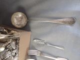 a box of silverware sitting on a table next to a box of utensils