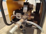 a close up of a machine with a hose attached to it
