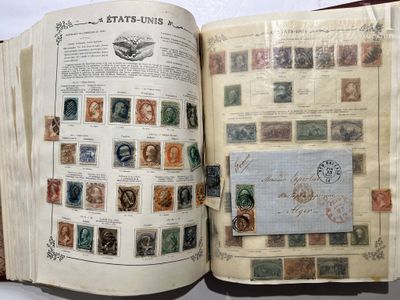 an open book with stamps on it on a table