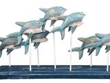 a group of sharks that are on sticks on a stand