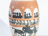 a vase with a picture of people riding horses on it